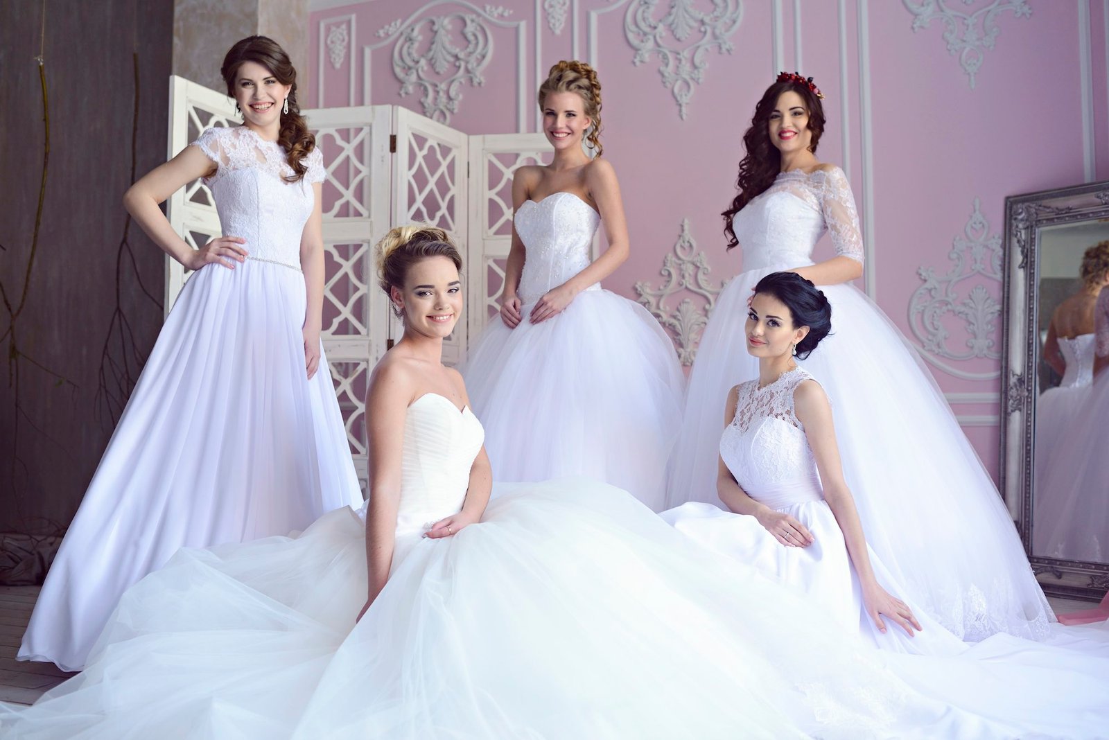 Brides in bridal gowns indoors