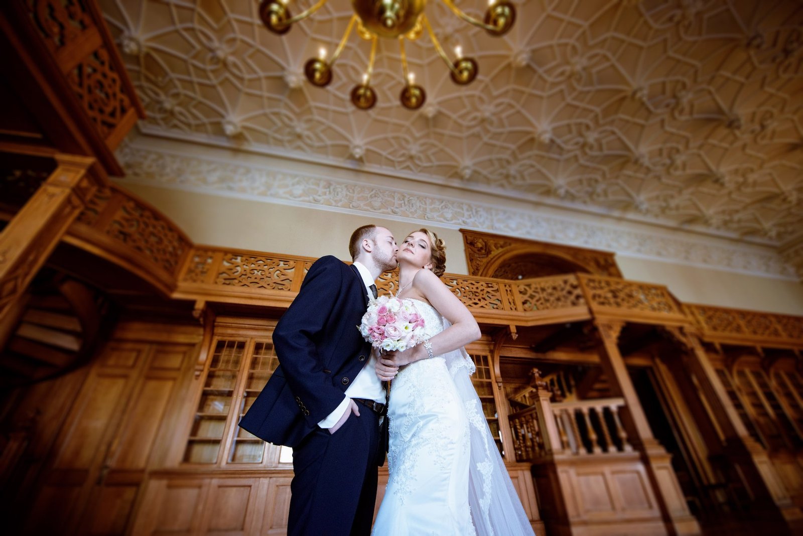 Wedding couple hugging indoors