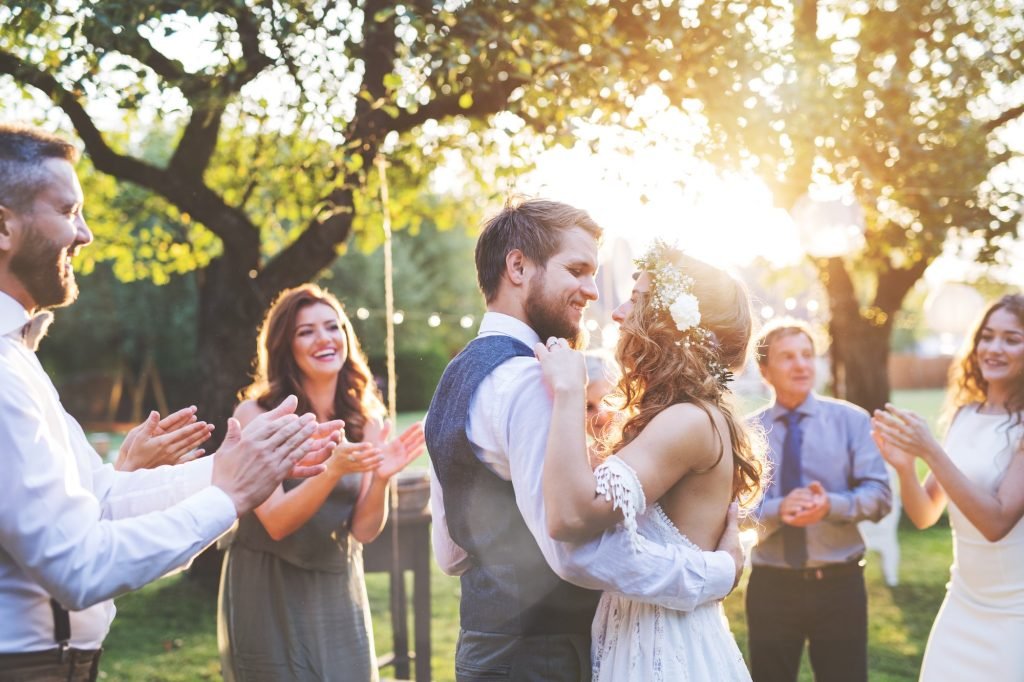 Bride and groom dancing at an outdoor reception