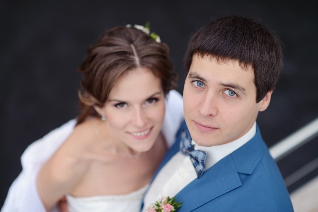 A wedding couple embracing on a yacht