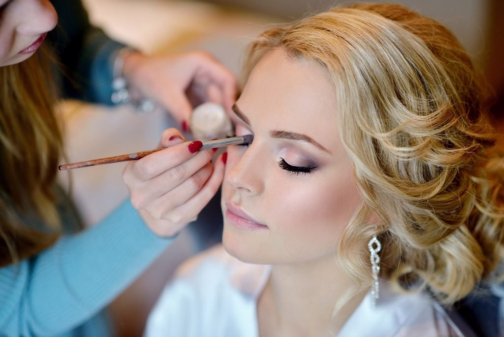 A bridal makeup artist at work