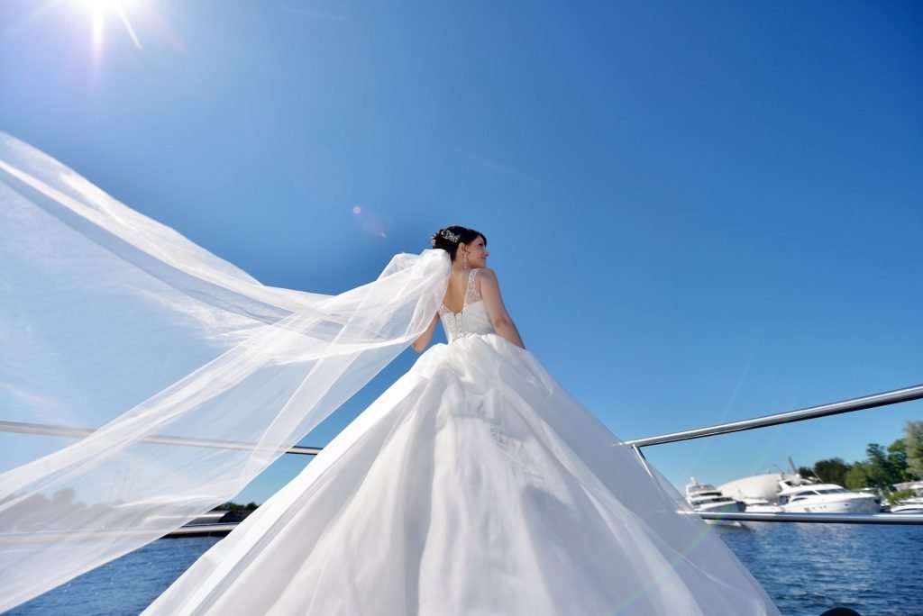 A bride in a lace veil on a yacht