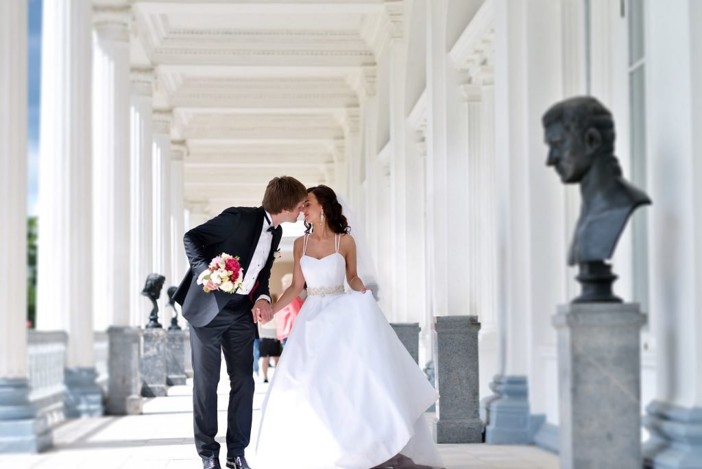 A wedding couple embracing outdoors